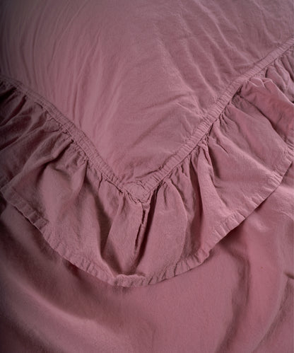 Close-up of stonewashed cotton fabric showing soft texture and breathable weave in old rose colour