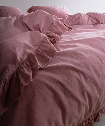 Lifestyle image of stonewashed old rose cotton duvet cover set in a calm and elegant bedroom setting