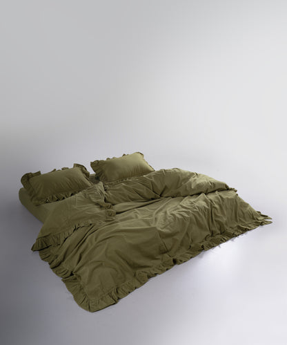 Olive green stonewashed cotton duvet cover set styled on a double bed
