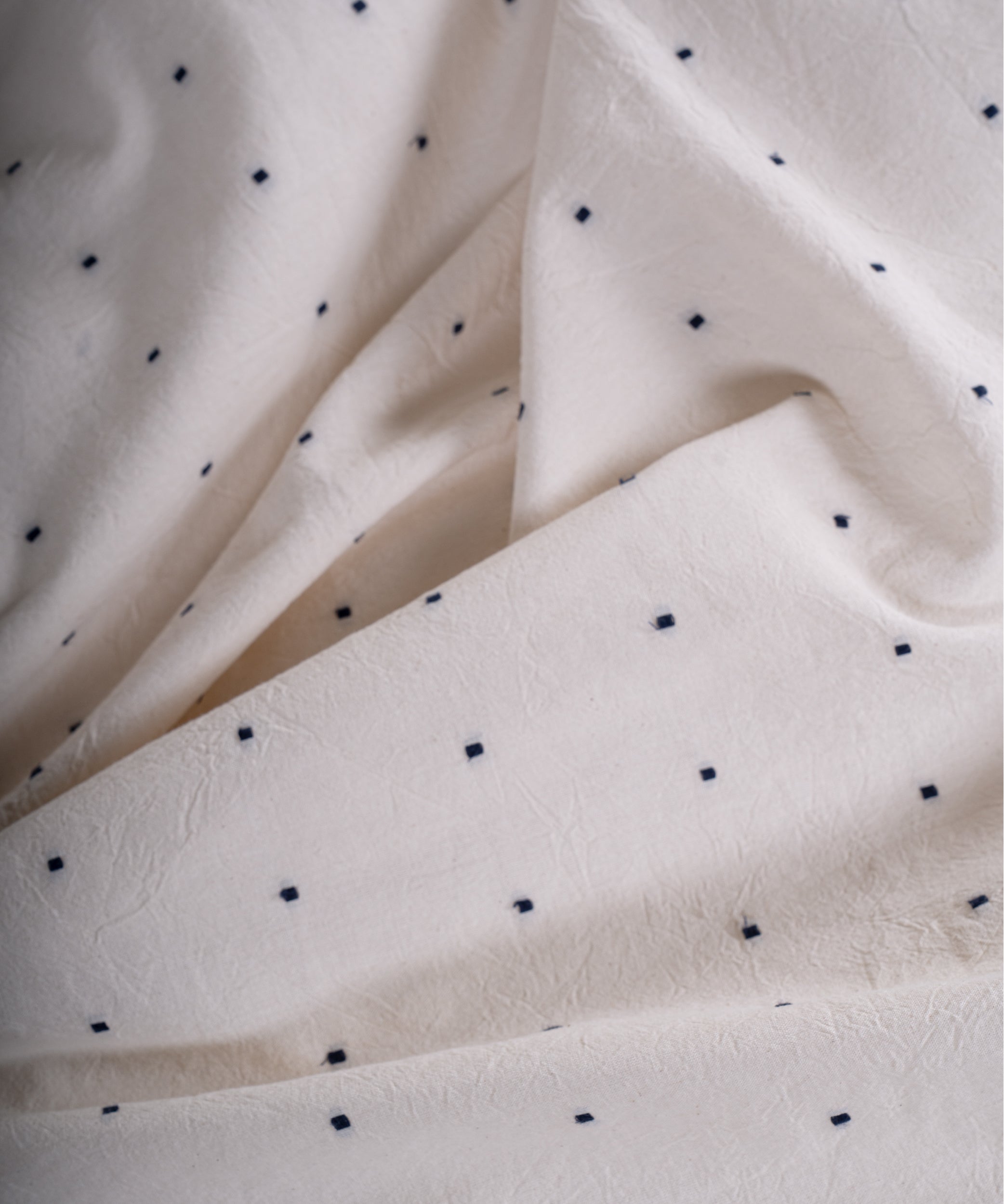 Button closure detail on garment washed cotton duvet cover, durable and practical bedding design