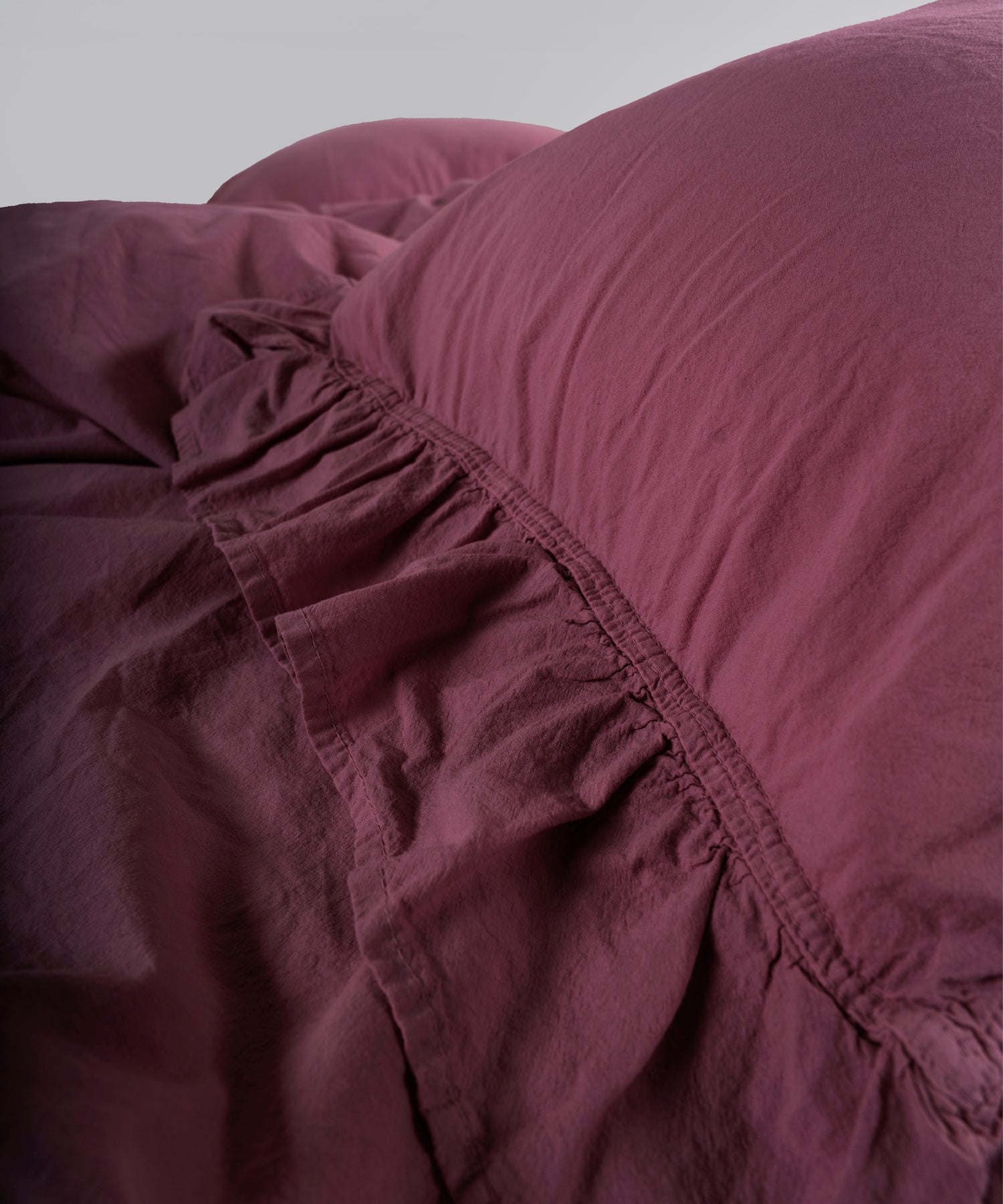 Raspberry stonewashed cotton duvet cover and pillowcase detail with envelope closure