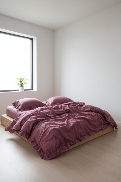 Raspberry stonewashed cotton duvet cover set styled on bed with soft texture and ruffle detailing