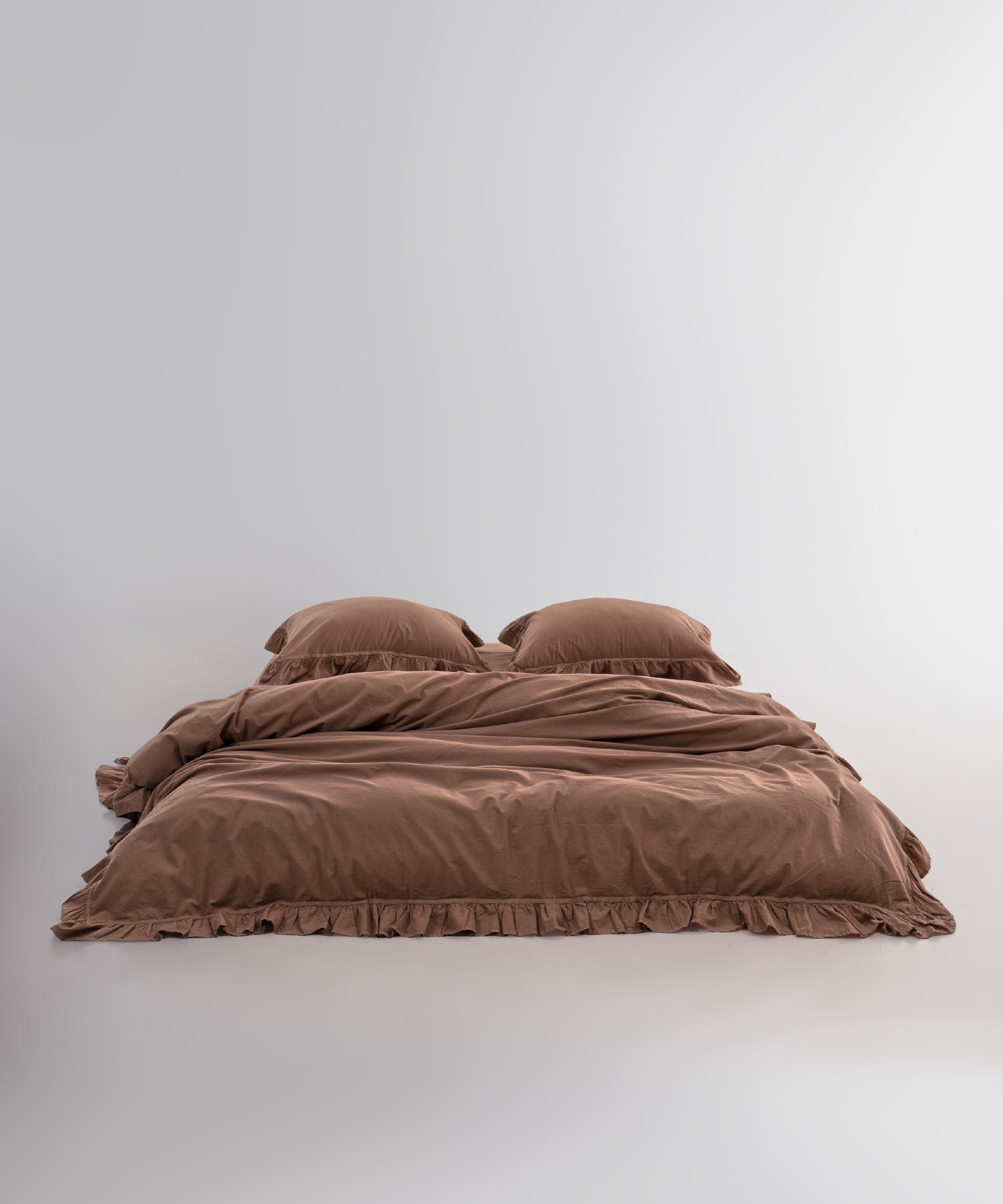 Close-up of ruffle detailing on stonewashed 100% cotton duvet cover set in wood smoke colour
