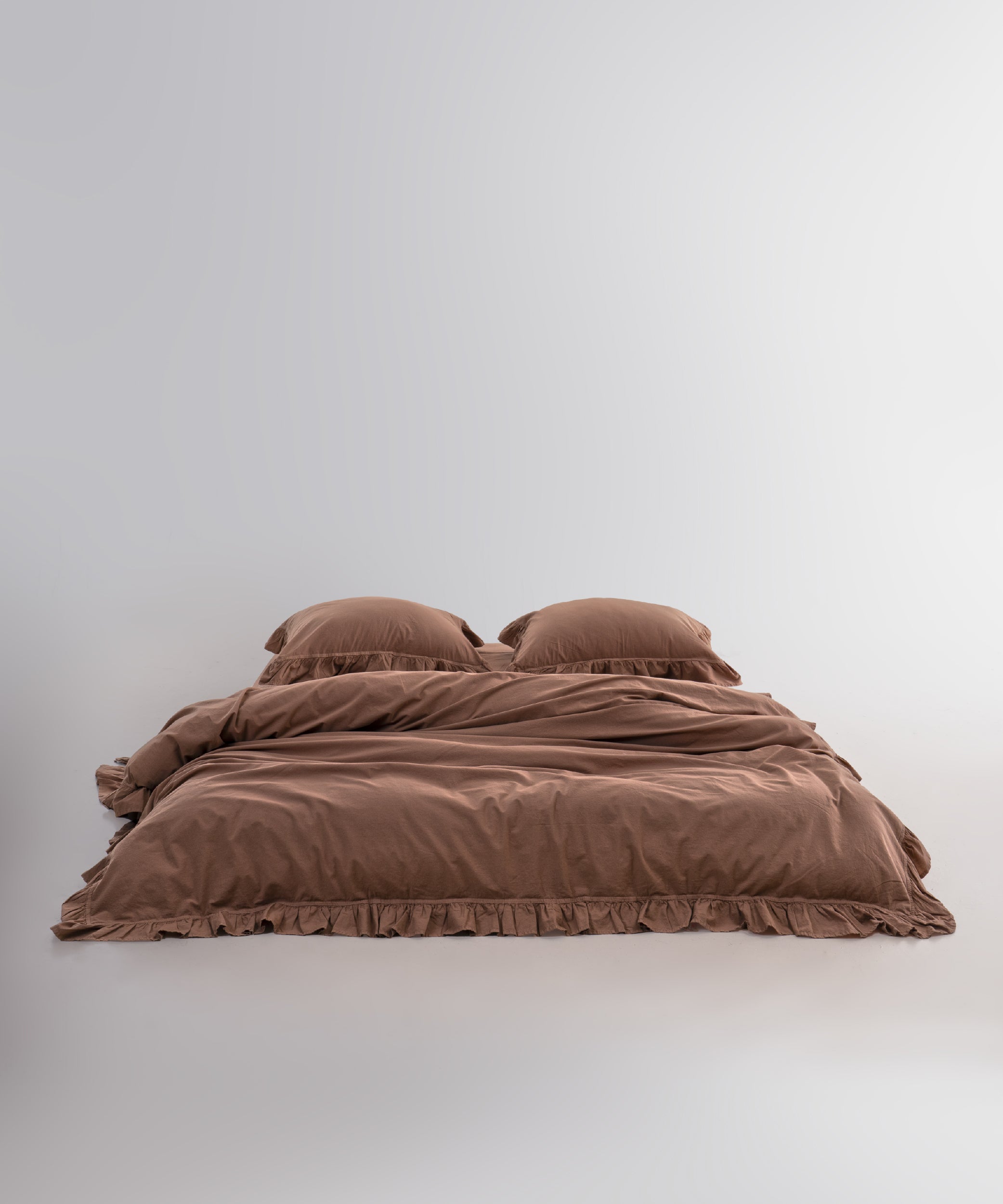 Close-up of ruffle detailing on stonewashed 100% cotton duvet cover set in wood smoke colour
