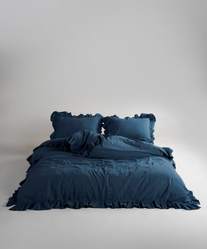 Stonewashed 100% soft cotton duvet cover set in dress blue with ruffled edges by Limasso London
