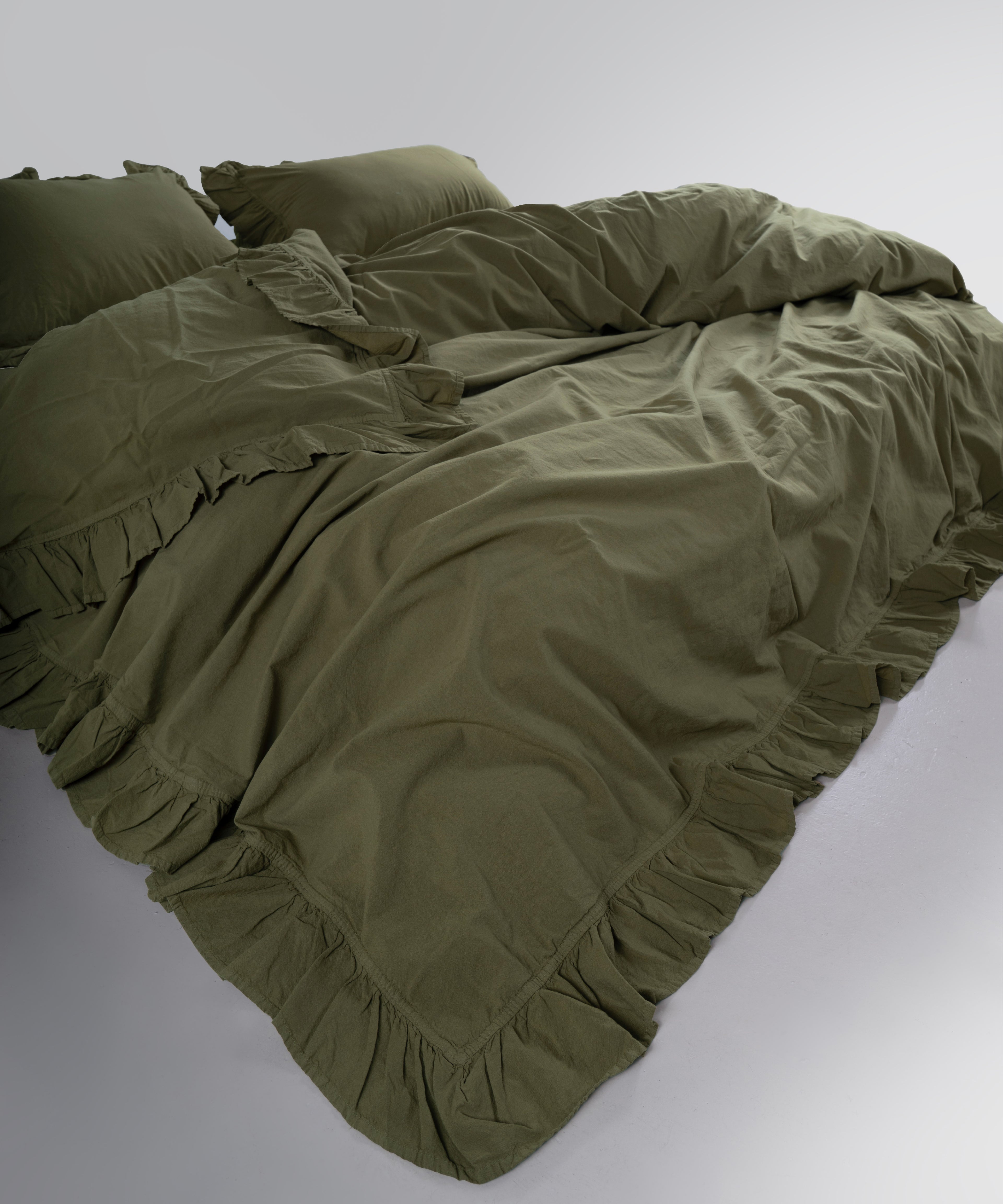 Close-up of stonewashed 100% cotton fabric texture in Capulet Olive colour
