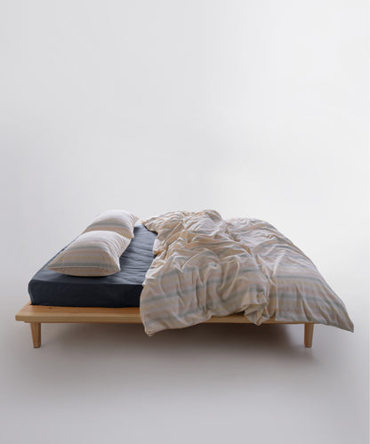 Striped garment washed cotton duvet cover set styled on a bed with a relaxed, natural bedroom look