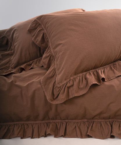 Stonewashed cotton pillowcases with ruffle edges in wood smoke shade, soft and breathable fabric
