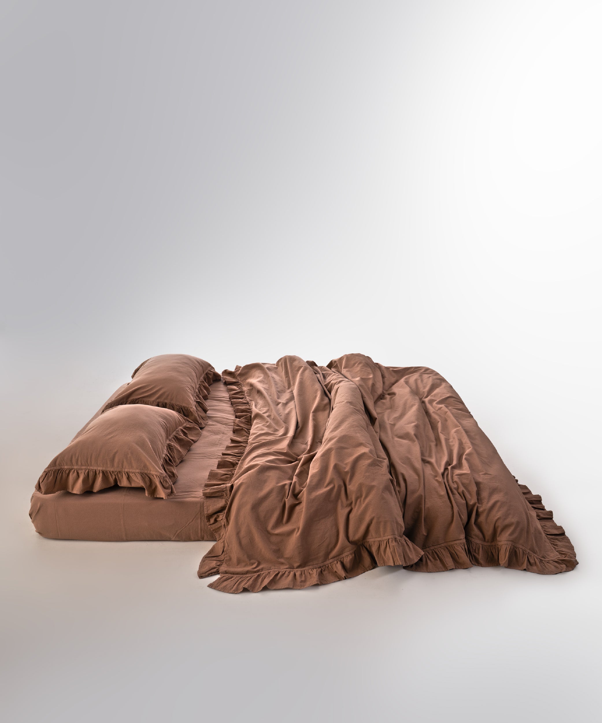 Wood smoke stonewashed cotton duvet cover set displayed on bed with relaxed European style design
